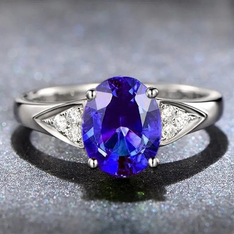 Women's zircon ring with natural blue or red zircon inlay, showing heart, water drop, or bell pattern on court style band.