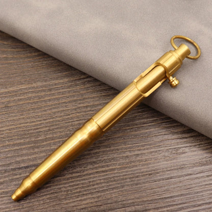 Brass tactical pen with press bolt mechanism showing cylindrical design and six ring details
