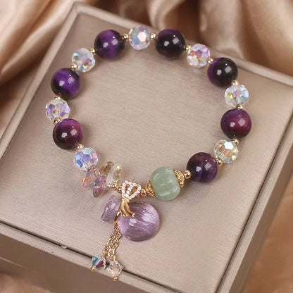 Women's forest style crystal bracelet with purple tigereye money bag pendant and rhinestone details