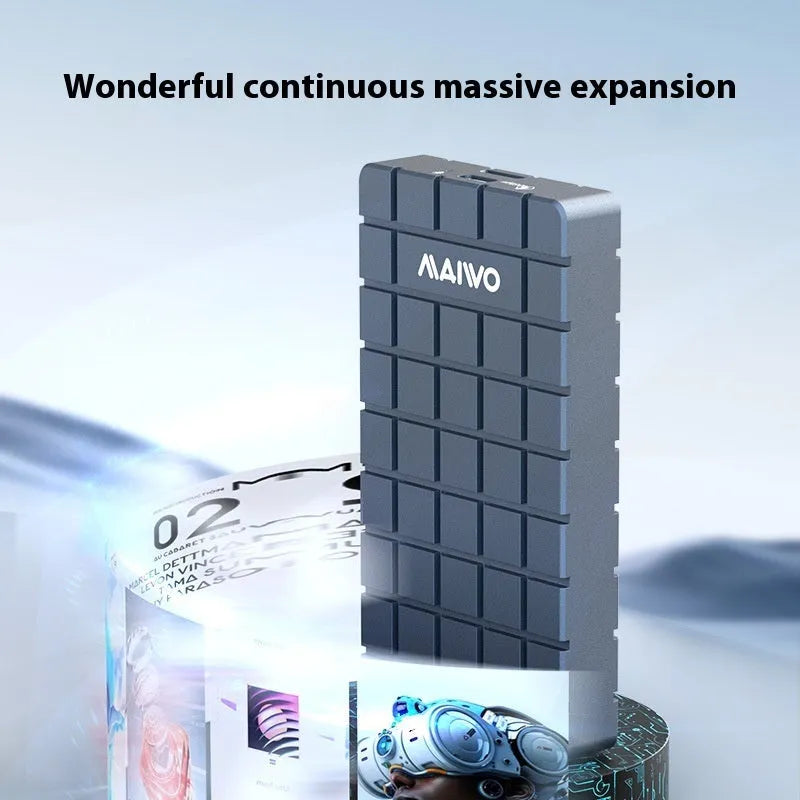 Silver aluminium alloy USB4 hard disk enclosure for M.2 SSDs, shown next to a laptop.