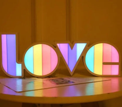 Rainbow halo LED love light with 'LOVE' word decoration on plastic casing.