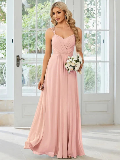 Women's sleeveless long dress with sling neckline and pleated A-line skirt in a solid colour.
