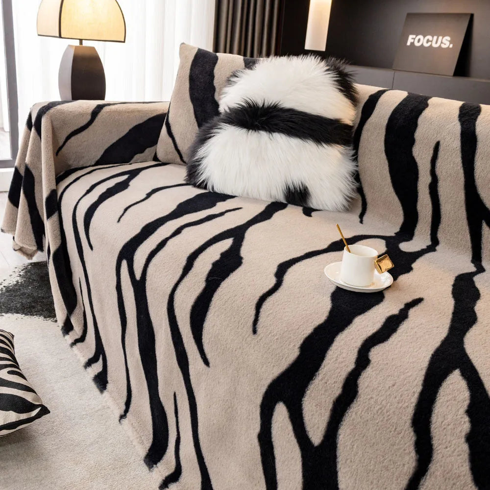 Zebra pattern sofa cover cloth in flannel fabric with non-slip backing, shown in caramel colour on a sofa