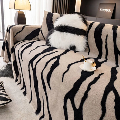Zebra pattern sofa cover cloth in flannel fabric with non-slip backing, shown in caramel colour on a sofa