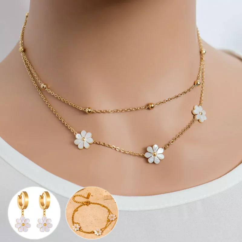Stainless steel daisy flower jewelry set with necklace, bracelet, and earrings in electroplated gold finish