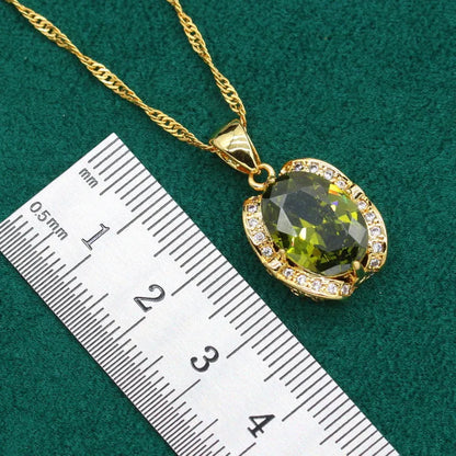 Olive green zircon jewellery suit set showing necklace with snake bone chain, matching earrings, and ring on a display.