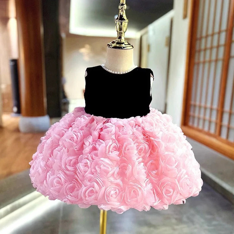 Pink girls summer dress with colour-matched design on hanger, showing polyester fabric texture