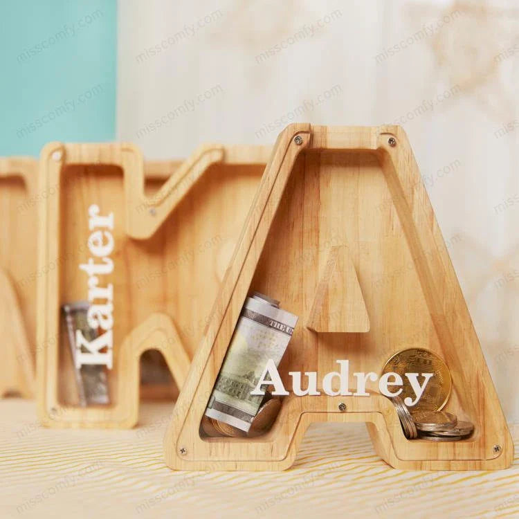 Wooden letter-shaped coin bank with clear glass panel to watch savings grow, a decorative and functional home accent.