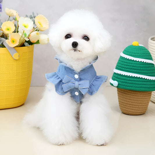 Blue denim dog dress with ruffles and integrated harness for leash attachment.