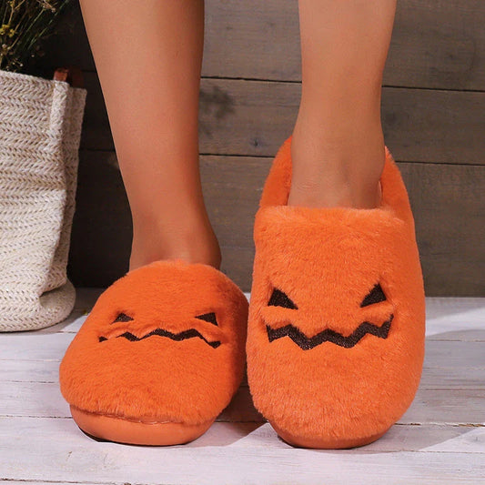 Cozy Halloween pumpkin-themed slippers with plush lining and non-slip soles for comfortable indoor wear