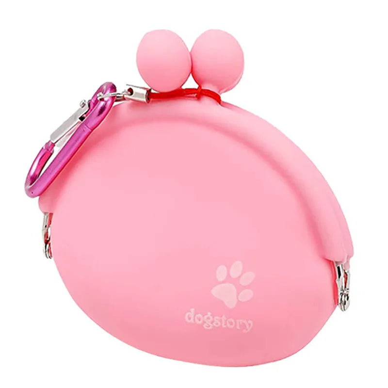 Yellow silicone dog training treat pouch with a black hook and loop waist strap, shown with dog biscuits.