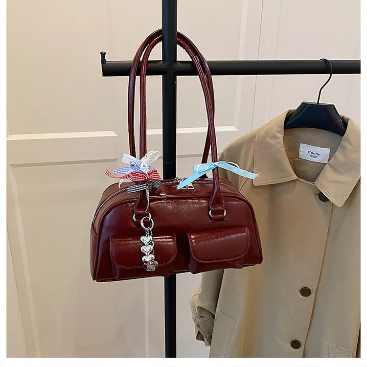 Retro brown PU leather women's pillow bag with a double shoulder strap and flap closure.