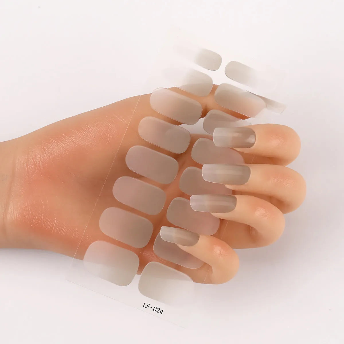 Sheet of 16 small design nail art stickers including cross, rose, tulip and marble patterns.