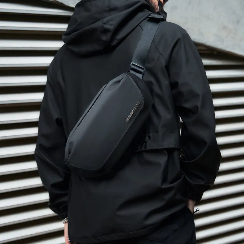 Black men's messenger bag with Oxford cloth exterior and cross-body strap for daily commuting