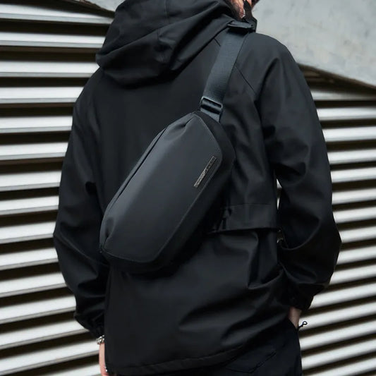 Black men's messenger bag with Oxford cloth exterior and cross-body strap for daily commuting