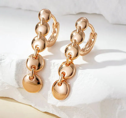 Gold finish hand-woven copper circle earrings showing textured surface and 5cm diameter