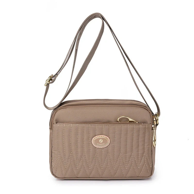 Casual women's crossbody messenger bag in nylon with polyester lining, available in multiple colors