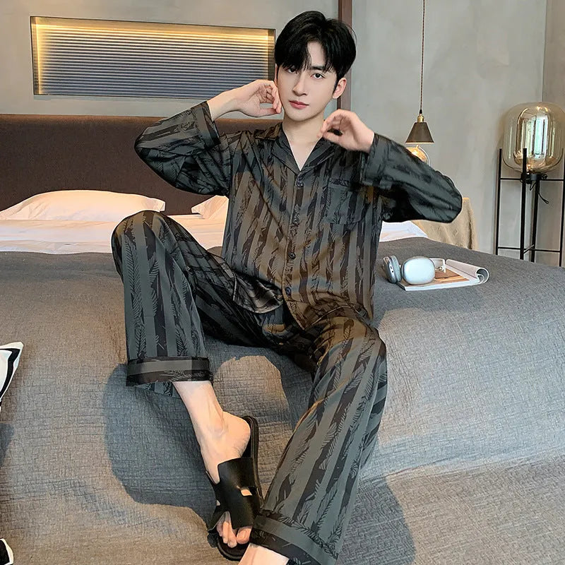 Black stripes men's ice silk pyjama set with V-neck top and long trousers on a hanger.