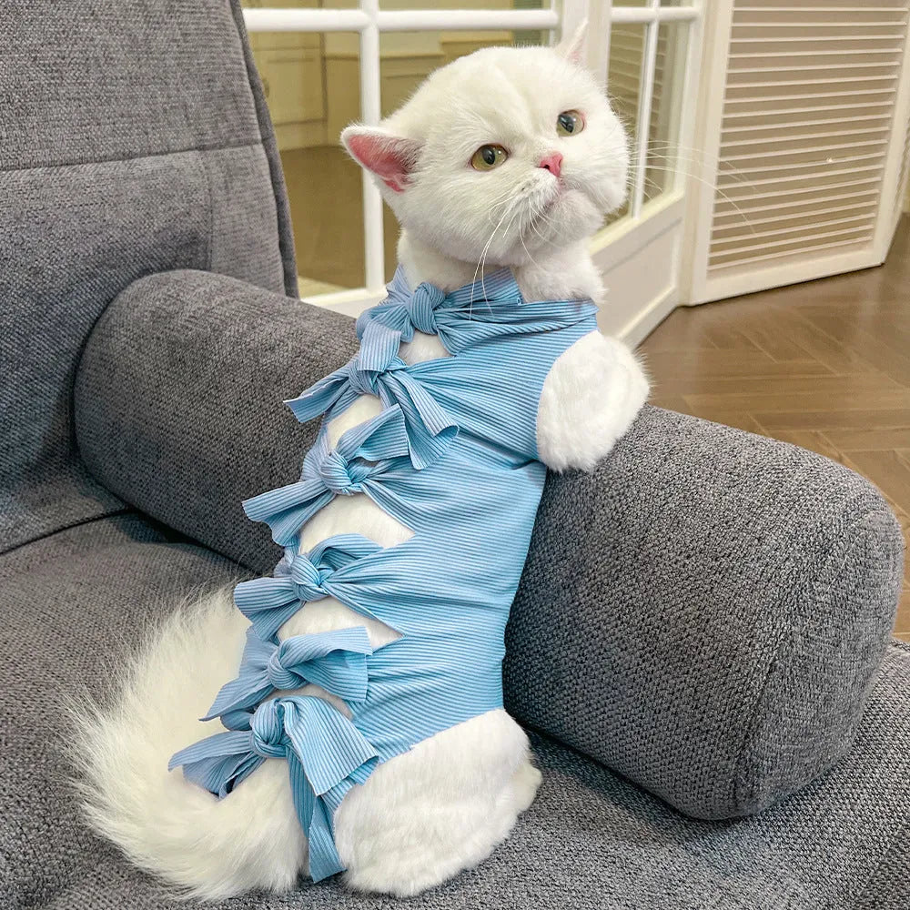 Lace-up cat sterilisation clothing in five colours including pink, purple, blue, brown, and green pineapple, showing adjustable fastening