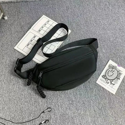 Men's polyester crossbody bag in black colour showing shoulder strap and front compartment