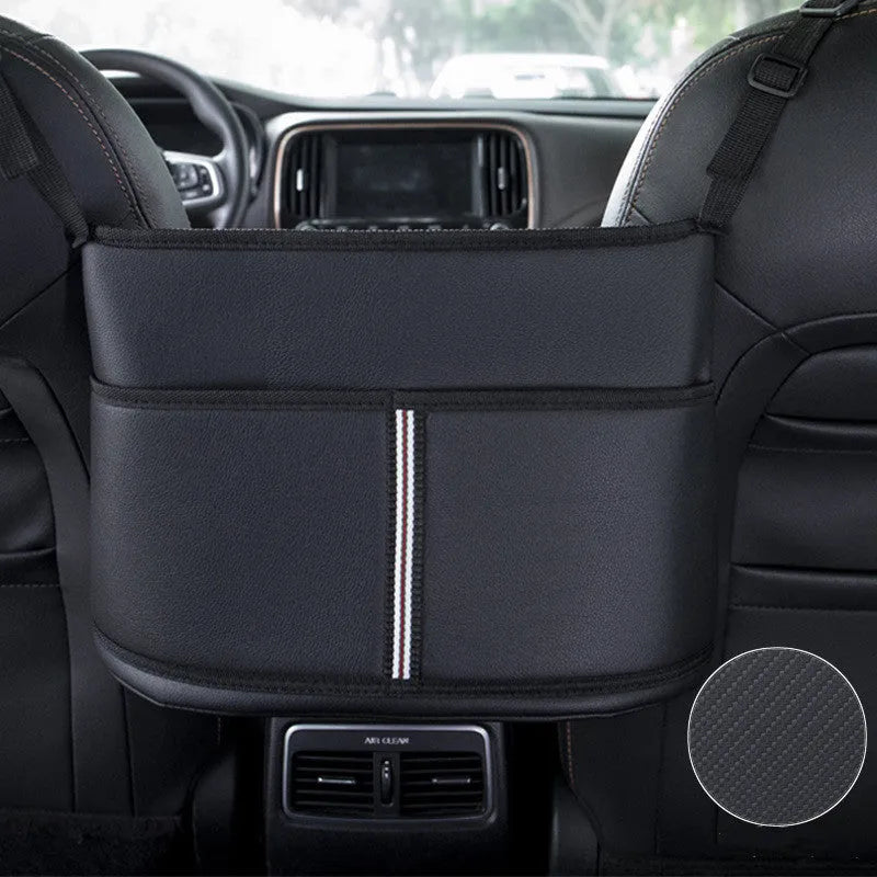 Black leather car seat gap storage bag with carbon fibre pattern, shown between car seats.