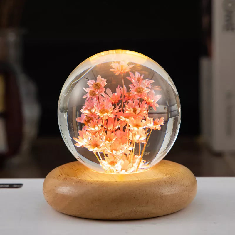LED Dandelion Crystal Ball Night Light with oak base emitting soft glow