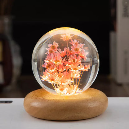 LED Dandelion Crystal Ball Night Light with oak base emitting soft glow