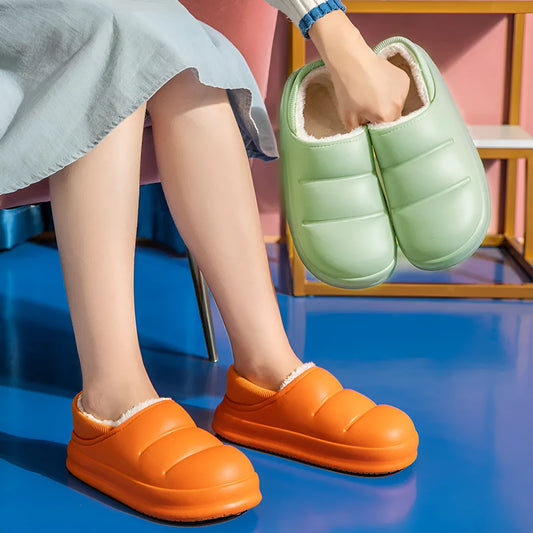 A pair of green waterproof EVA garden slippers with a plush lining and textured non-slip sole.