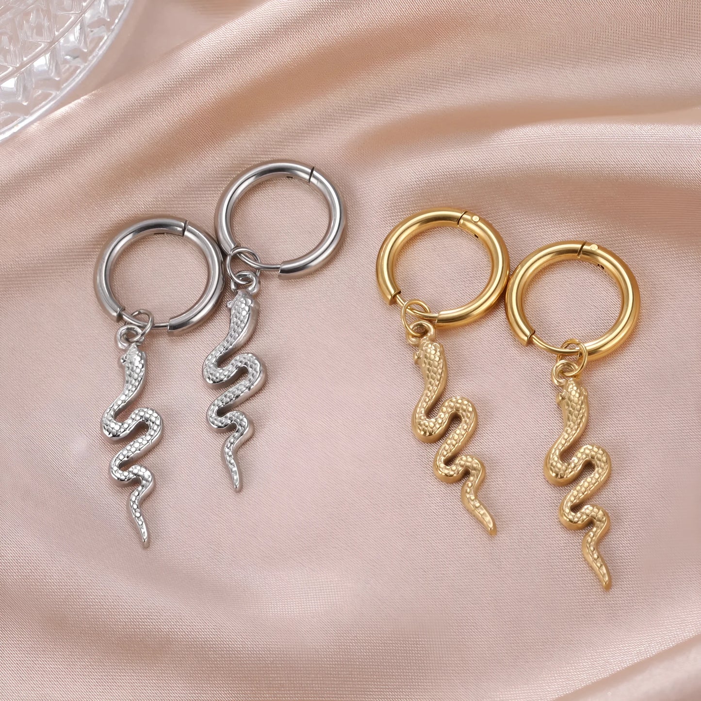 Gold coloured snake-shaped vintage clip-on earrings made from stainless steel.