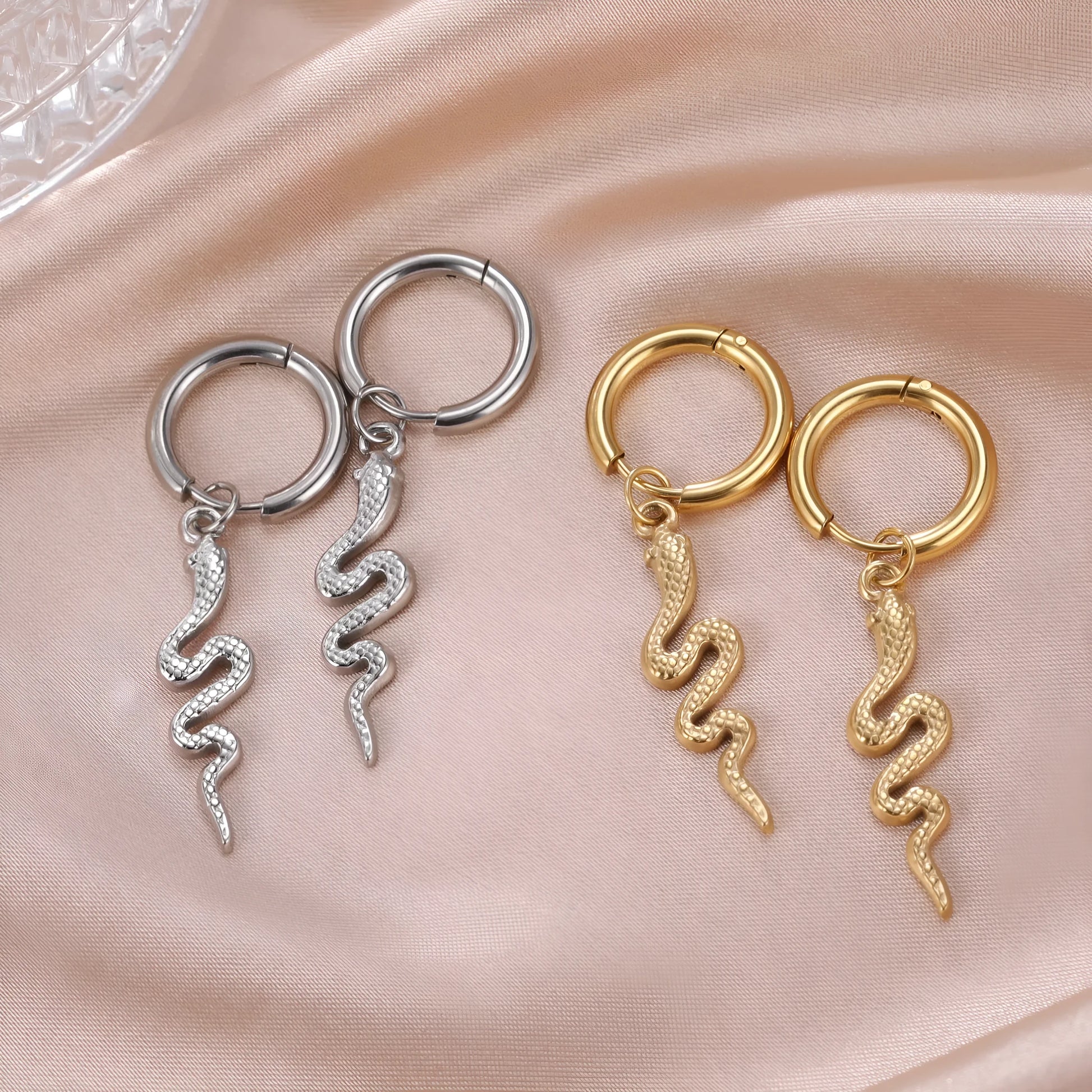 Gold coloured snake-shaped vintage clip-on earrings made from stainless steel.