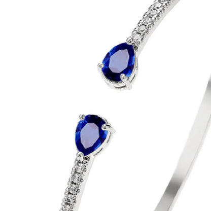 Close-up of a multi-zircon inlay fashion bracelet in copper, shown in blue and white colour options.