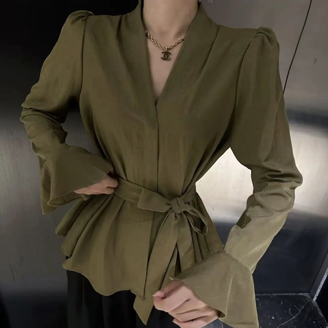 Women's French-style irregular collar long sleeve tied shirt in black with bell sleeves and tied front