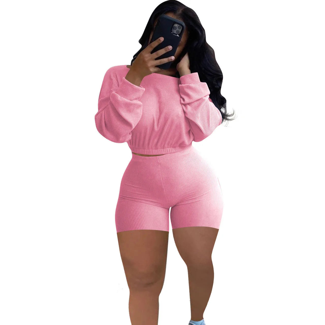 Women's long sleeve off-the-shoulder top and shorts two-piece set in a solid colour.