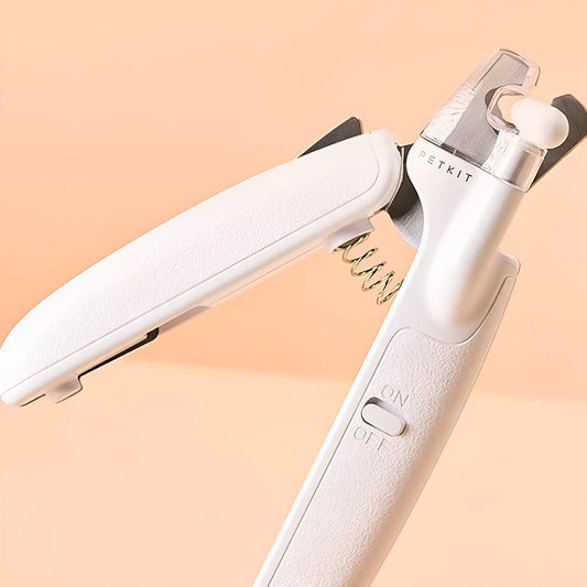 White pet nail clippers with LED light, anti-splash guard, and built-in nail file on a flat surface.