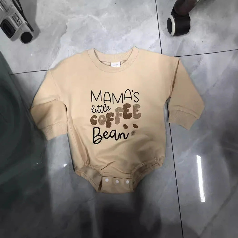 Apricot coloured infant jumpsuit with embroidered alphabet detailing and long sleeves