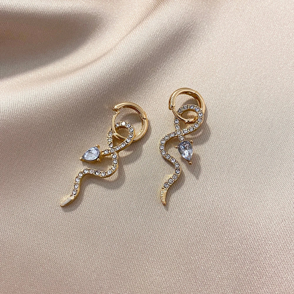 Pair of golden snake-inspired dangle earrings with a captivating and elegant design