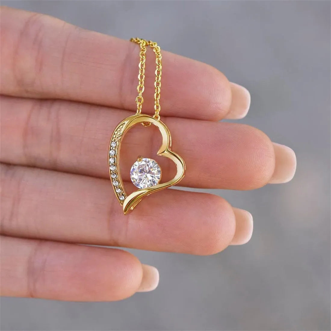 Silver hollow openwork heart pendant necklace presented in a gift box with a card.