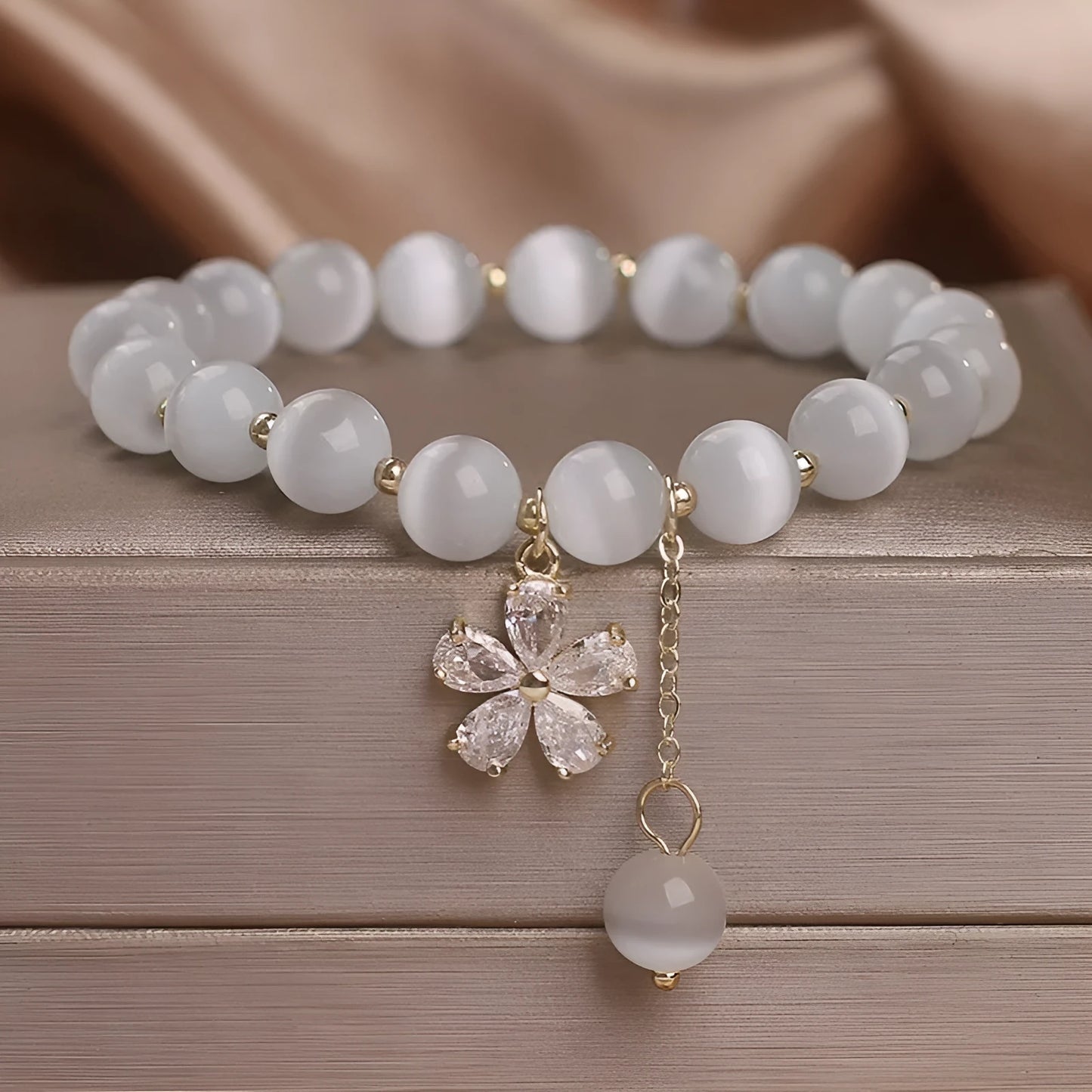 White cat's eye crystal women's bracelet with floral tassels and adjustable safety buckle clasp