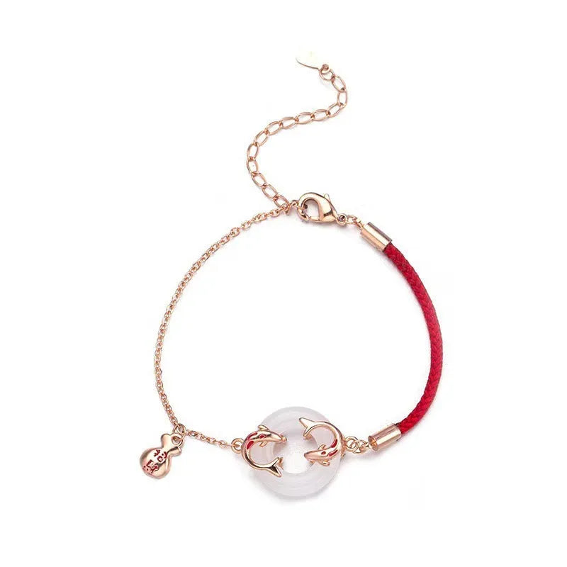 Women's festive koi bracelet with peace buckle in red rope design showing fishtail details