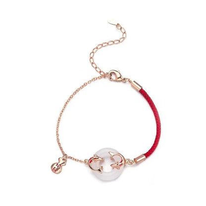 Women's festive koi bracelet with peace buckle in red rope design showing fishtail details
