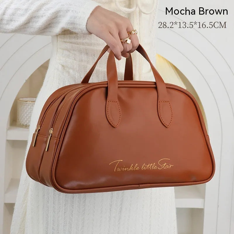 Leather travel toiletry bag with dry-wet separation compartments in caramel mocha colour with letter detailing