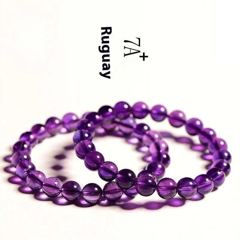 Natural amethyst scattered beads bracelet from Uruguay showing purple crystal beads in various sizes from 4mm to 16mm diameter