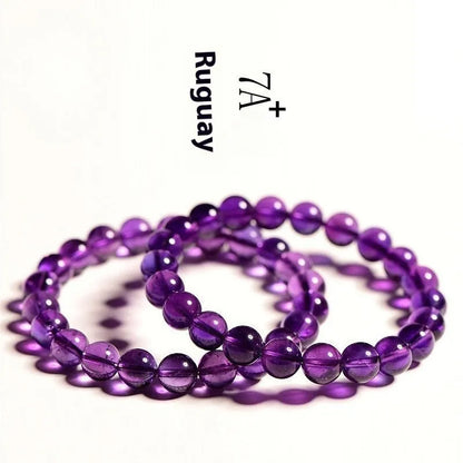 Natural amethyst scattered beads bracelet from Uruguay showing purple crystal beads in various sizes from 4mm to 16mm diameter
