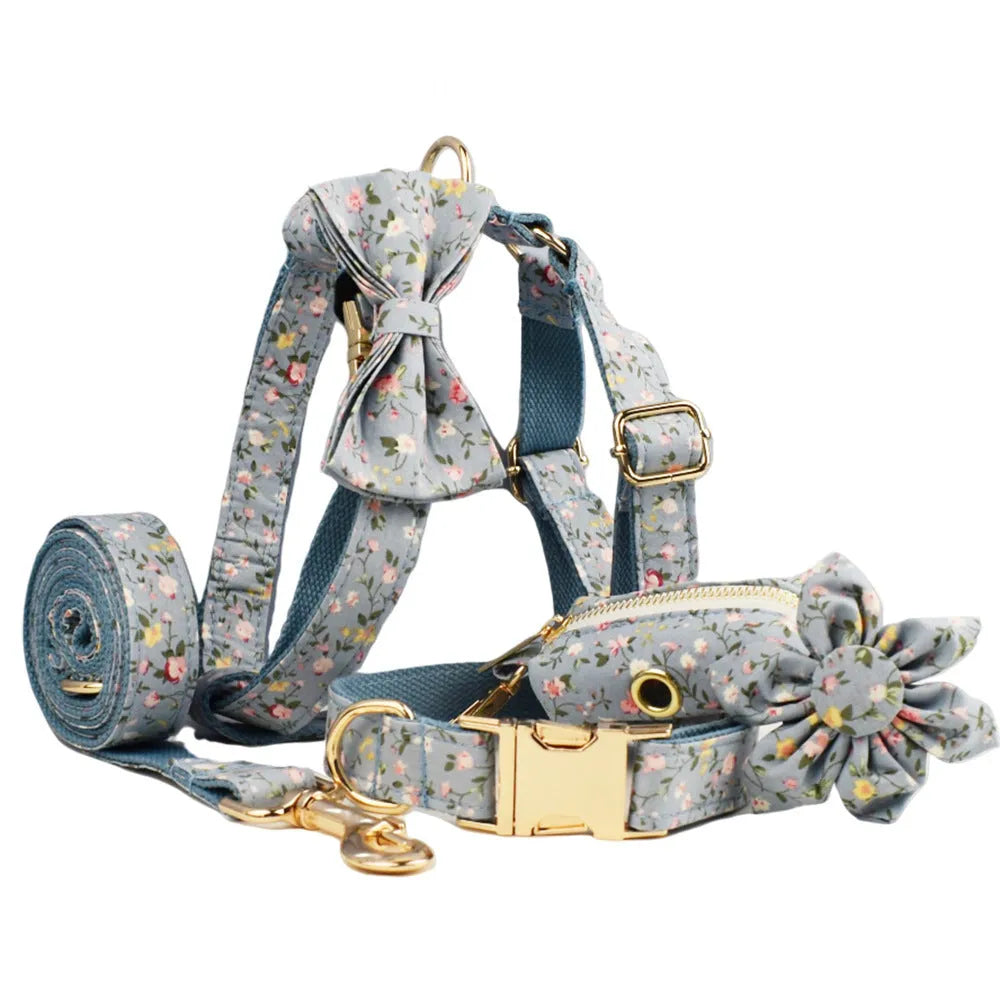 Blue floral dog collar set with adjustable sizes, includes leash, vest, bow, and poop bag on polyester cotton cloth.