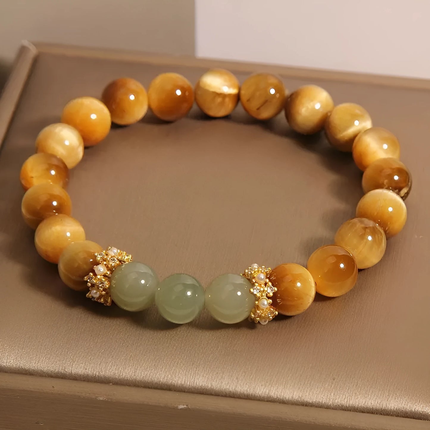 Natural yellow Tiger's Eye bracelet with Hetian jade elements and gold gourd charm on wrist
