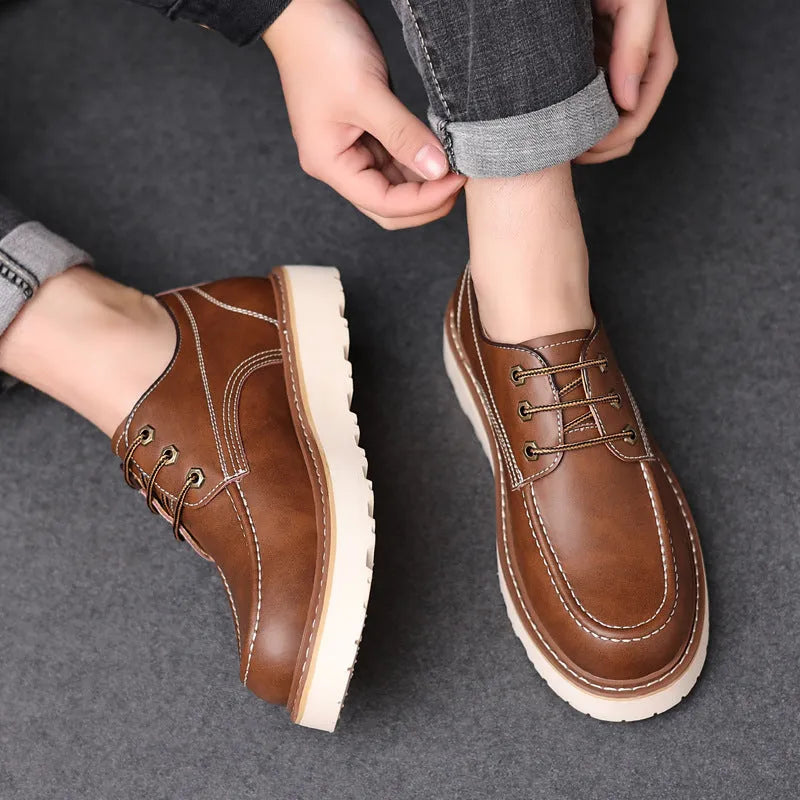 Men's black low-top Martin boots with a round toe and rubber sole on a white background.
