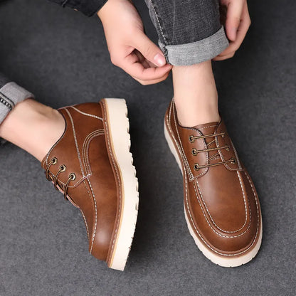 Men's black low-top Martin boots with a round toe and rubber sole on a white background.