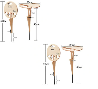 Wooden folding wine table with ground stakes holding wine bottle and glasses outdoors