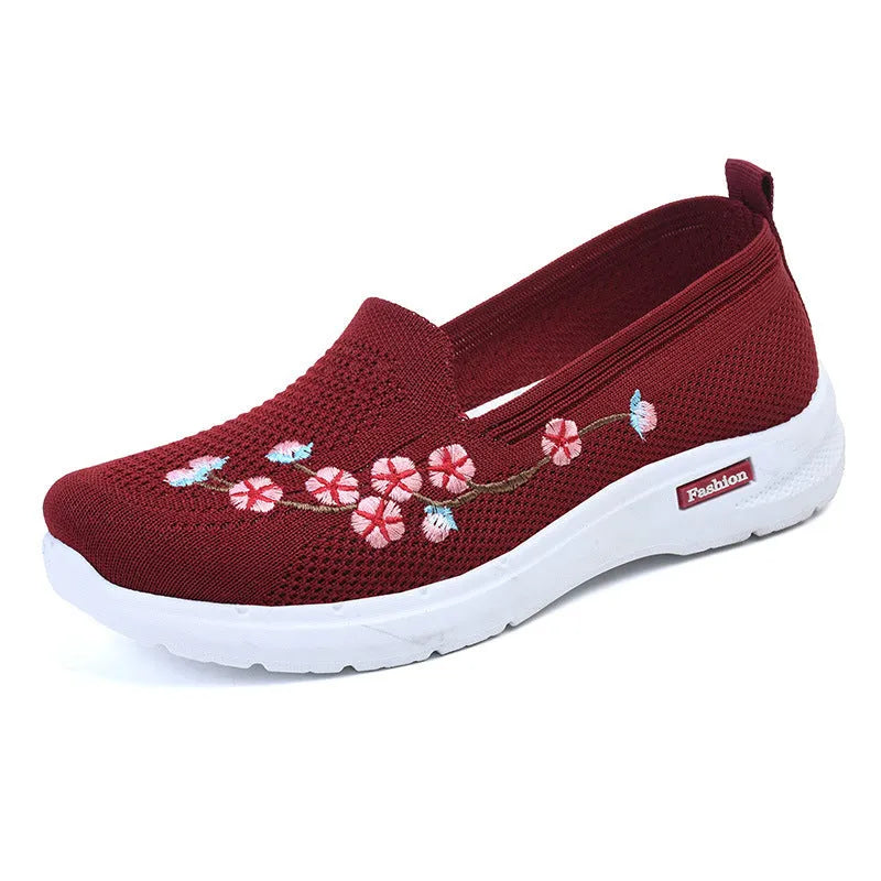 Women's low-top embroidered fly knit sports pumps in wine red with anti-slip sole.