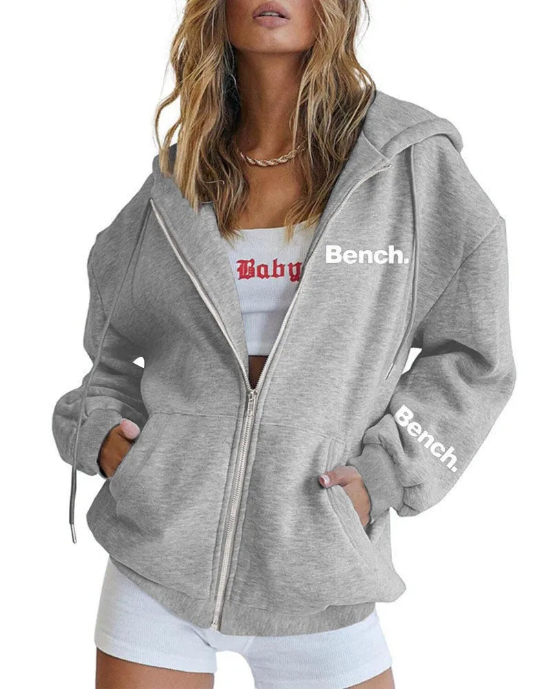 Grey loose fit men's sweater coat with a front zipper, modelled casually.